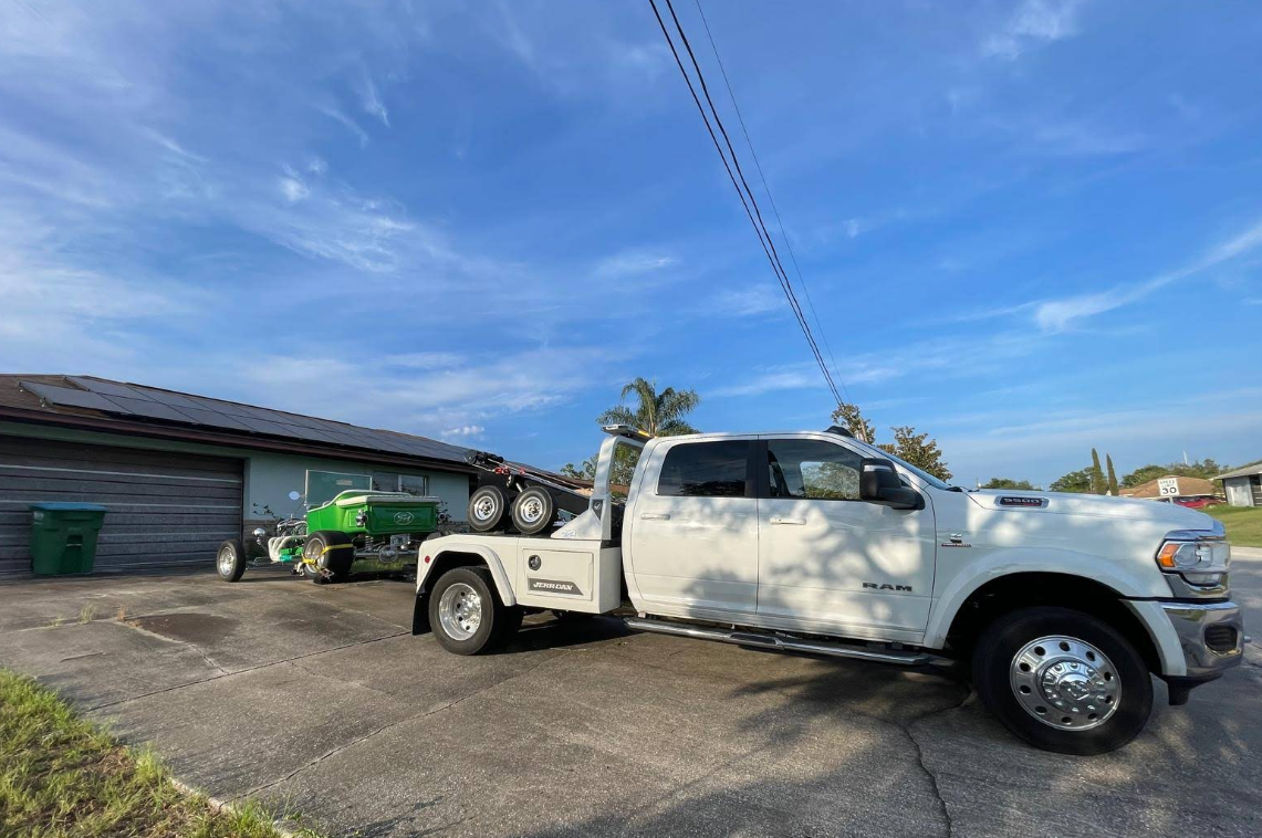 Tow truck hauling a custom green hot rod