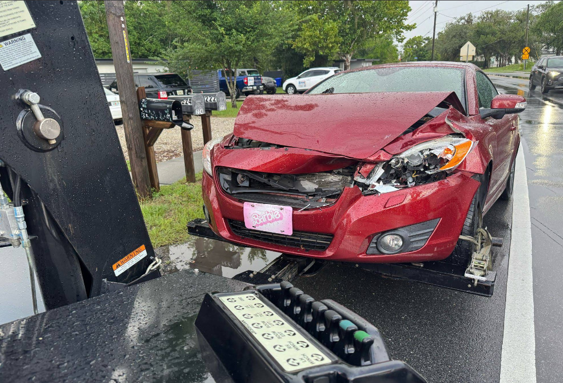 Collision-damaged vehicle secured on a flatbed